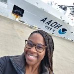 A girl taking selfie near a AAON ship