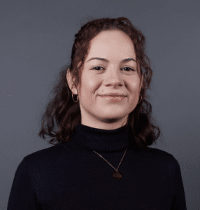 Image of speaker Ana Cristina Vasquez smiling, wearing a black turtleneck.